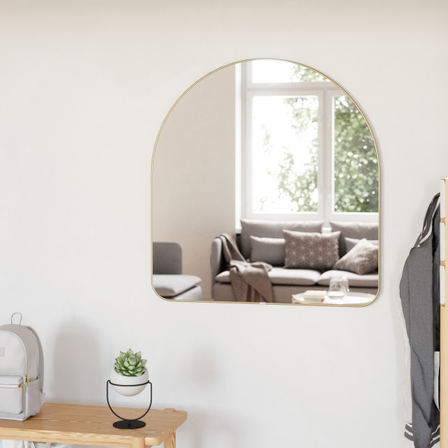 Umbra Hubba Arched Mirror - Brass In A Bedroom Setting