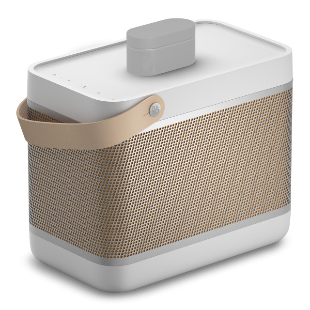 Bang & Olufsen Beolit 20 Bluetooth Speaker - Grey Mist angle with earbuds case charging