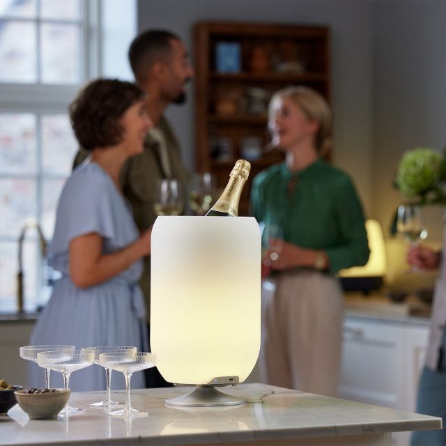 Kooduu Atmos Brushed Silver on the kitchen counter with a bottle of champagne
