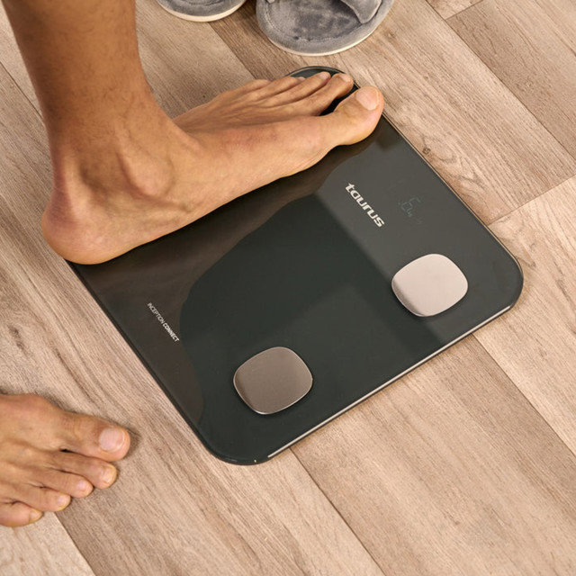 Taurus Digital Glass Bathroom Scale on the wooden floor