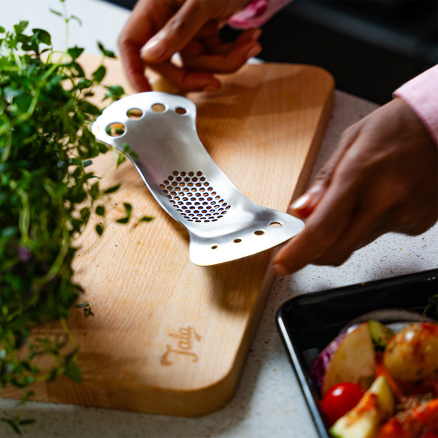 Tala Garlic Rocker and Herb Stripper in use