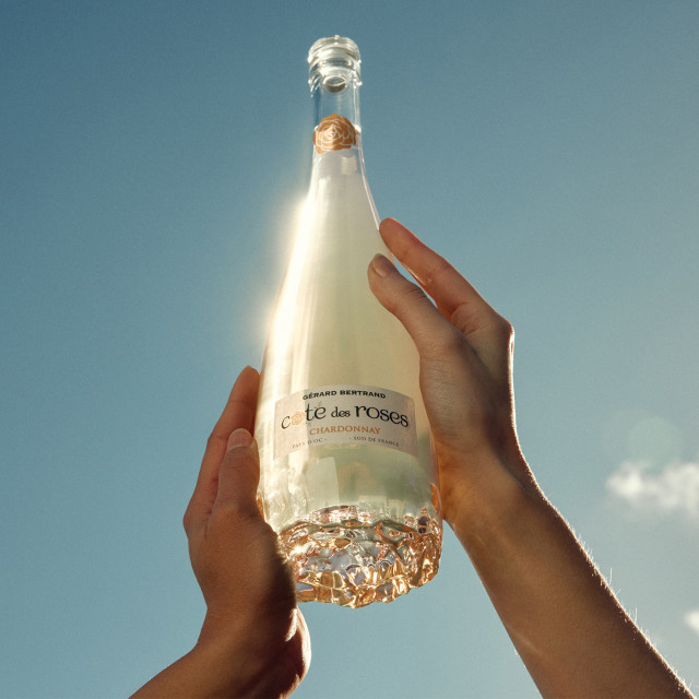 Gerard Bertrand Cote Des Roses Chardonnay, 750ml being held in the air