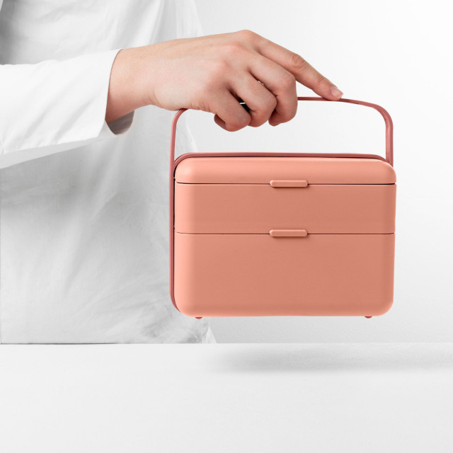 Blim Plus Bauletto Lunchbox, Medium - Flamingo Pink held on the kitchen counter