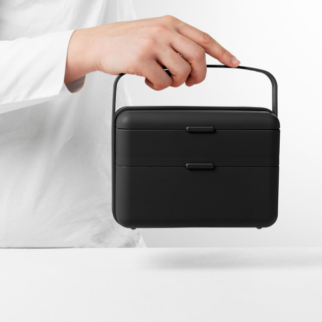 Blim Plus Bauletto Lunchbox, Medium - Carbon Black held on the kitchen counter