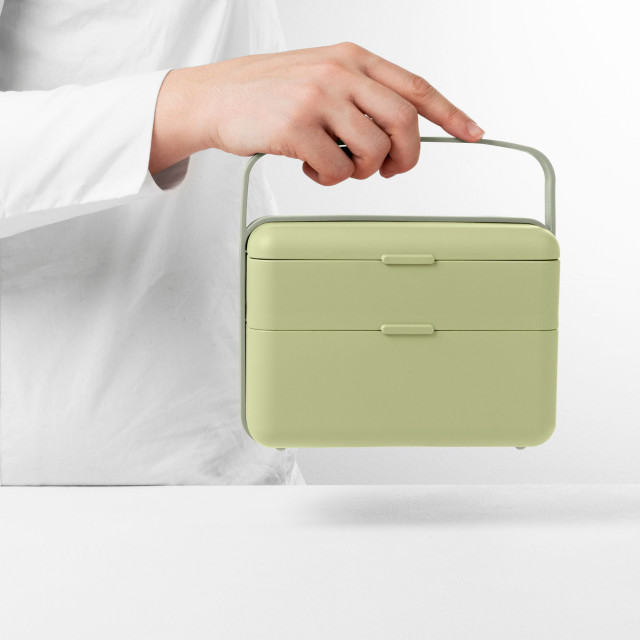 Blim Plus Bauletto Lunchbox, Medium - Forest Light held on the kitchen counter