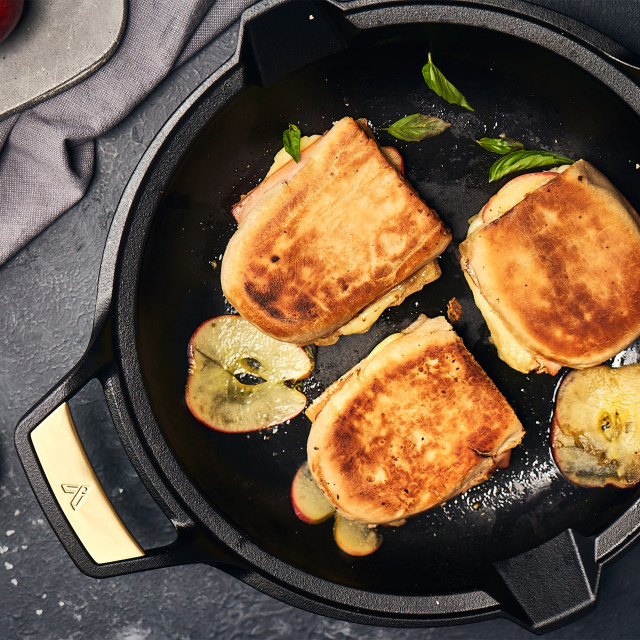 Victoria Signature Soft Seasoned Finish Double Handle Skillet, 33cm with food on the table