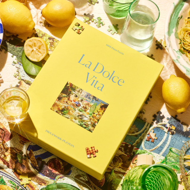 Piecework Puzzles La Dolce Vita 1000 Piece Puzzle on the table with lemons