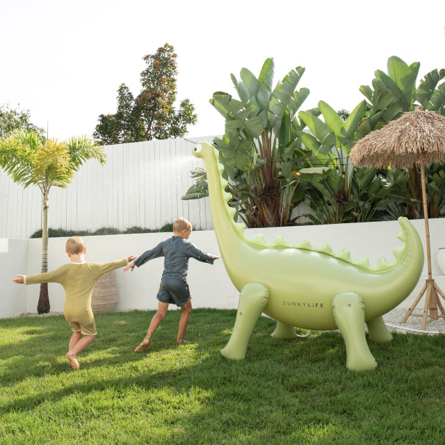 Sunnylife Giant Dino Sprinkler in the lawn