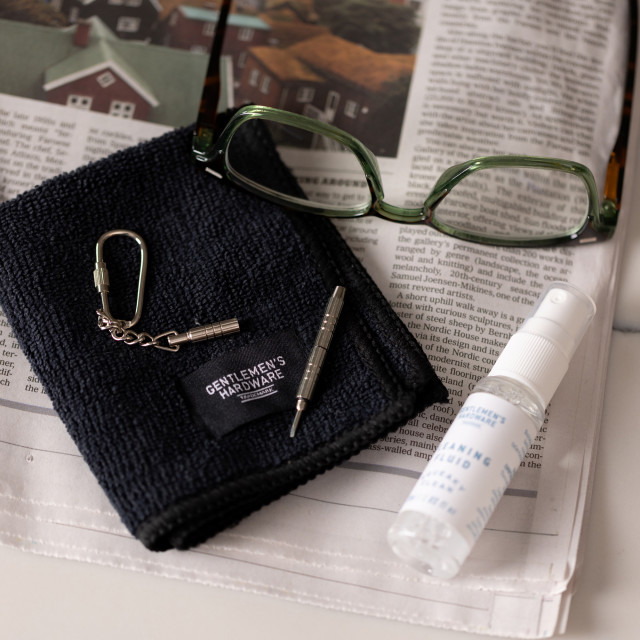 Gentlemens Hardware Squeaky Clean & Repair Kit on the table with a pair of spectacles