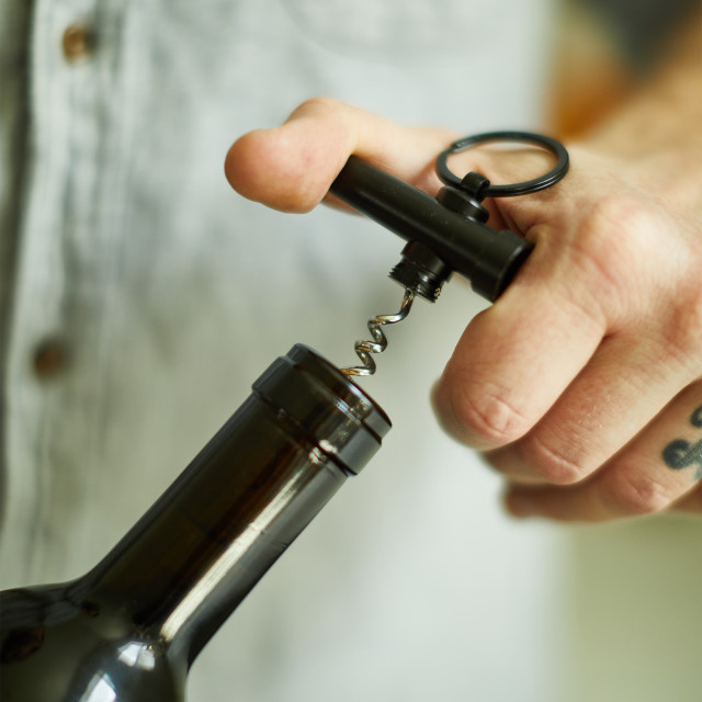 Gentlemens Hardware Mini Corkscrew Keychain on a wine bottle