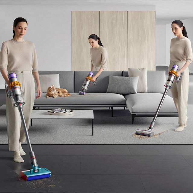 Dyson V15 Detect Submarine Cordless Vacuum Cleaner in use cleaning floor, couch and carpet