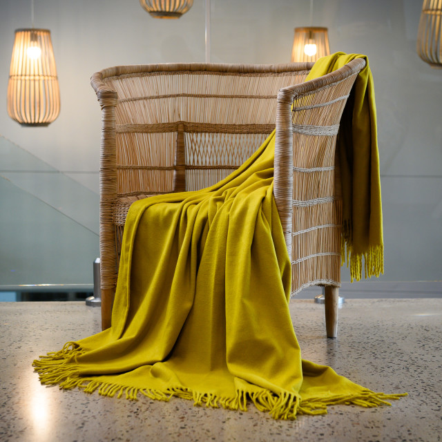 Aranda Gold Nugget Melody Throw, 150cm x 200cm on a chair