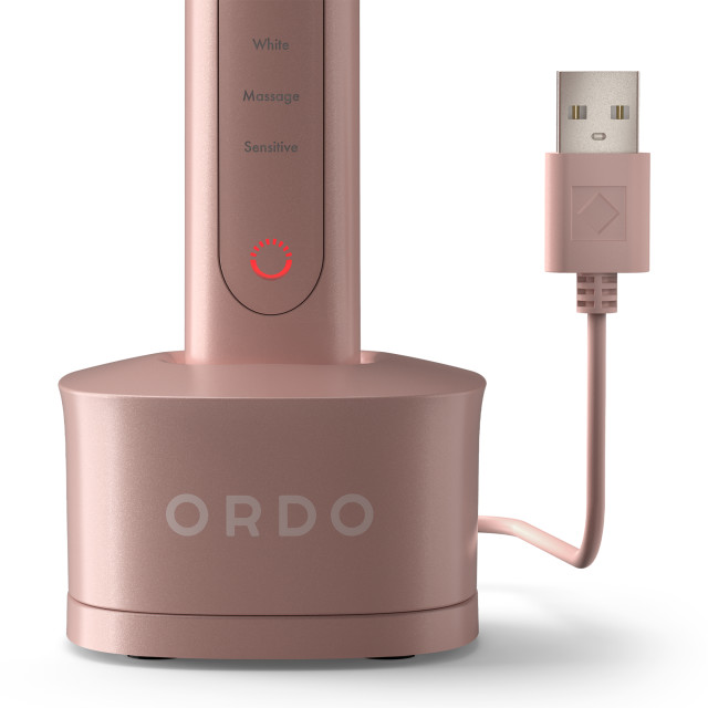 Ordo Sonic Plus Toothbrush - Rose Gold showing the product's charging station