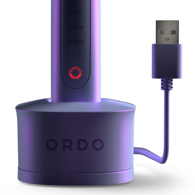 Ordo Sonic Plus Toothbrush - Pearl Violet showing the product's charging station