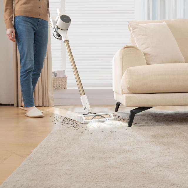 Dreame R10 Cordless Stick Vacuum Cleaner, 350W - Rose Gold cleaning up dirt from carpet