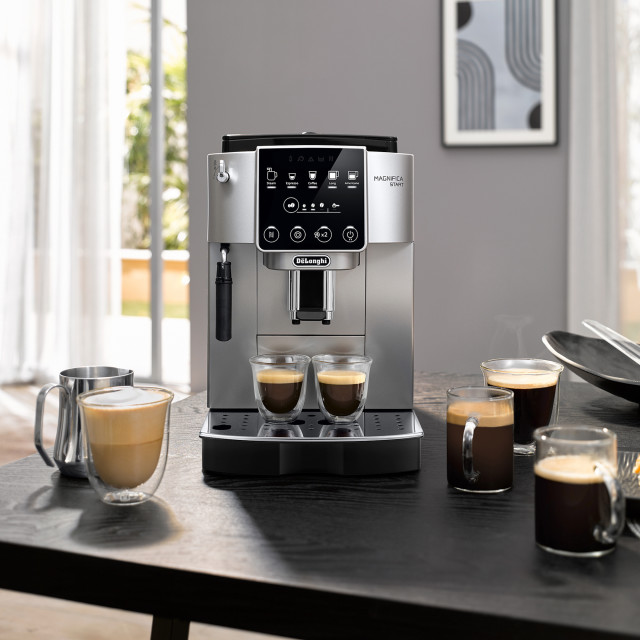DeLonghi Magnifica Start+ Bean-to-Cup Coffee Machine on the table with cups of coffee