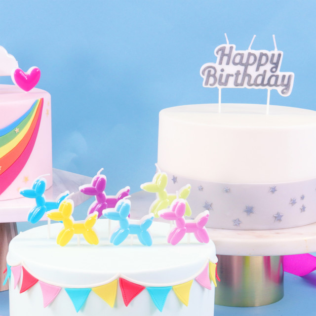 PME Happy Birthday Candle - Silver on a cake