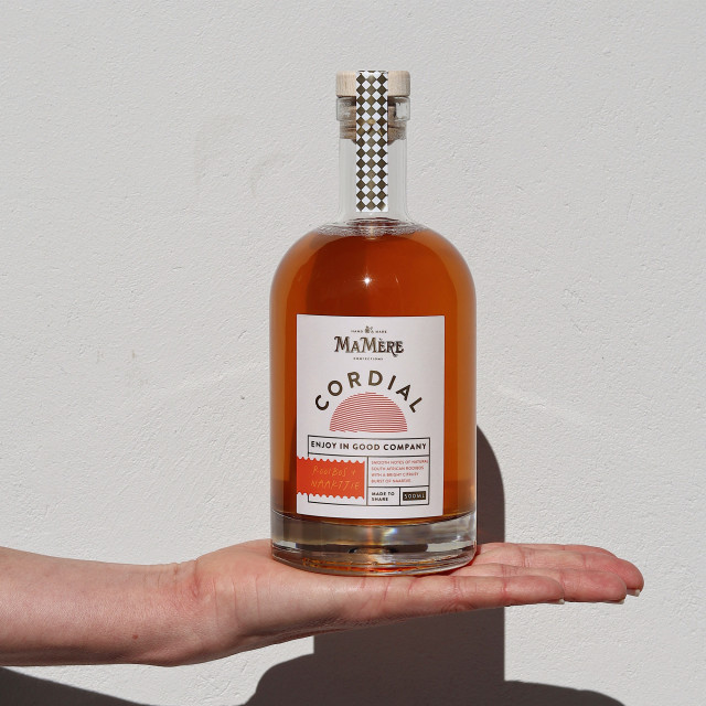 Ma Mere Confections Rooibos & Naartjie Cordial, 500ml handheld showing scale