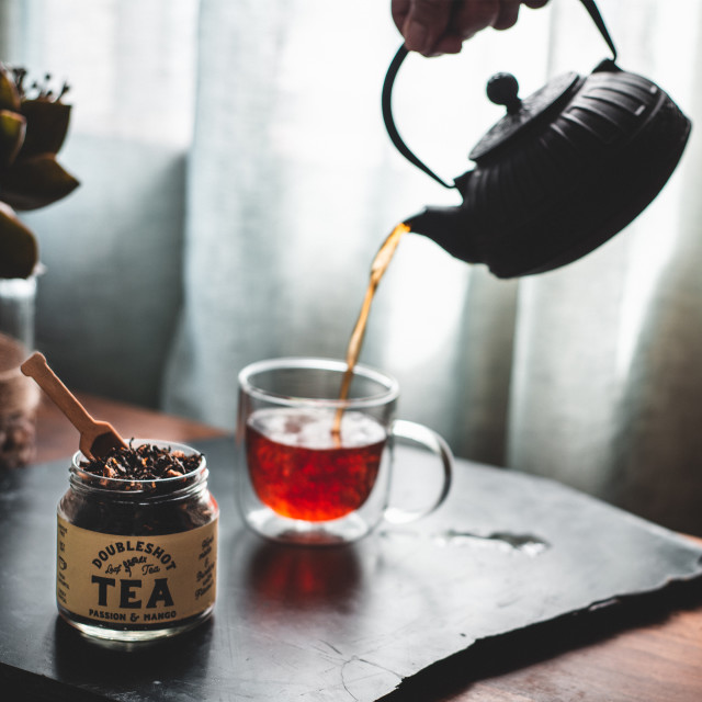 Doubleshot Coffee & Tea Premium Loose Leaf Passion Mango Green Tea, 80g on the table