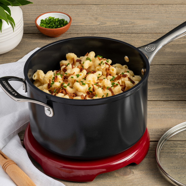 Le Creuset Essential Non-Stick Ceramic Saucepan with Glass Lid - 16cm with food on the table