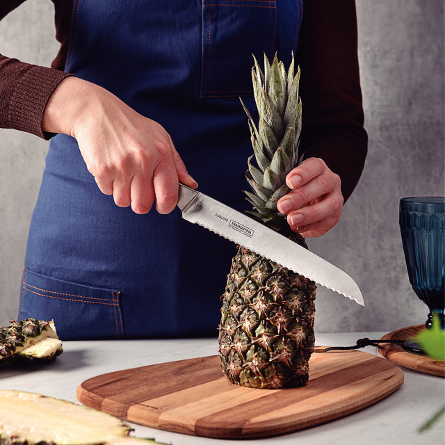 Tramontina Stainless Steel Bread Knife, 20cm slicing a pineapple