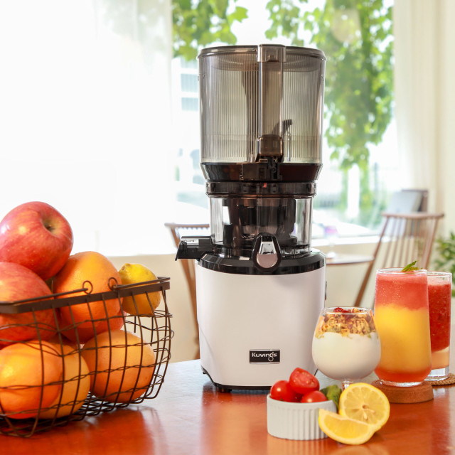 Kuvings Auto10 Cold Press Juicer - Pearl White on the table