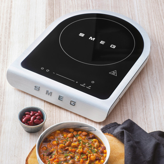 Smeg Portable Induction Plate with Probe - Matte White with a bowl of food