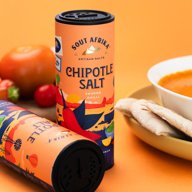 Funky Ouma Sout Afrika Chipotle Chilli Salt, 150g on the table with a bowl of soup