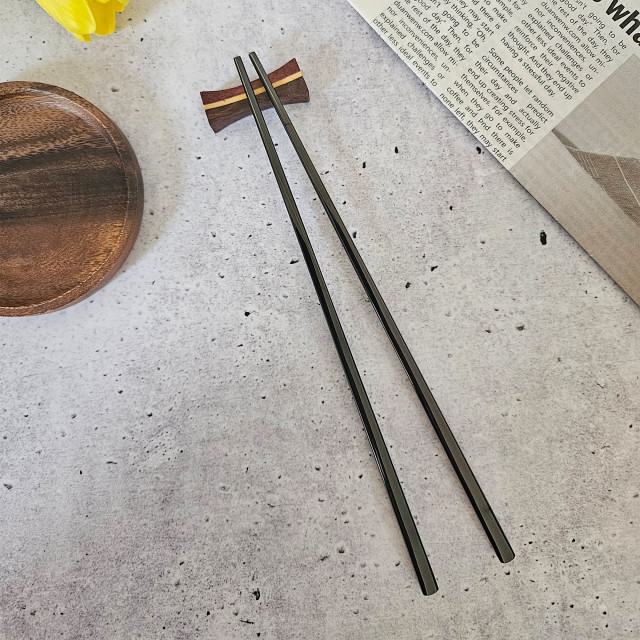 Nicolson Russell Stainless Steel Chopsticks, Set of 2 - Black on the table