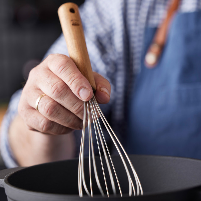 HOLM Stainless Steel Whisk with Acacia Wood Handle in a bowl
