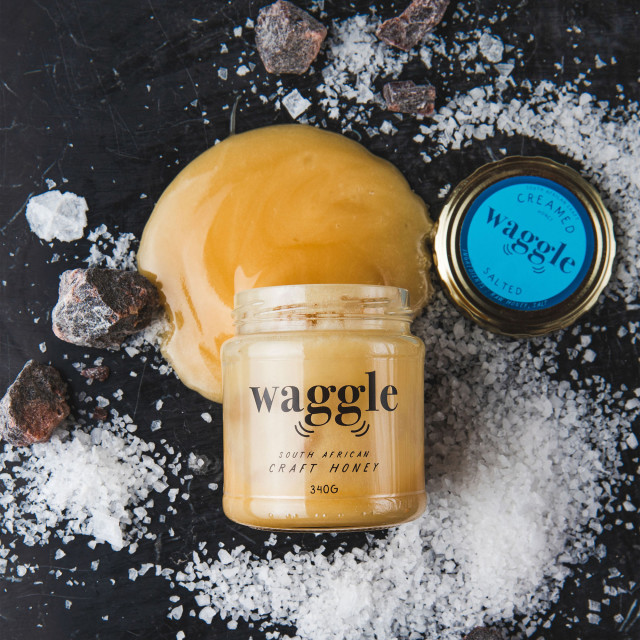 Waggle Salted Craft Honey, 340g with salt on the table