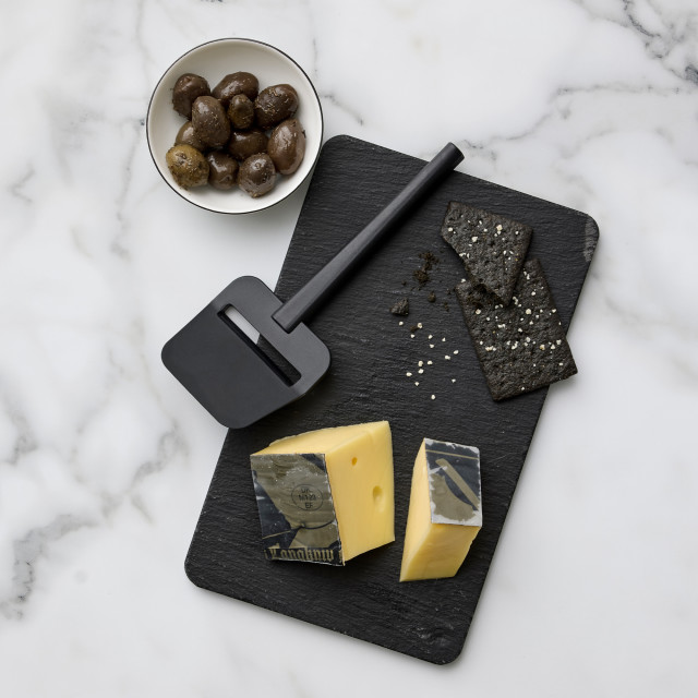 Rosti Emma Cheese Slicer - Black with a slice of cheese