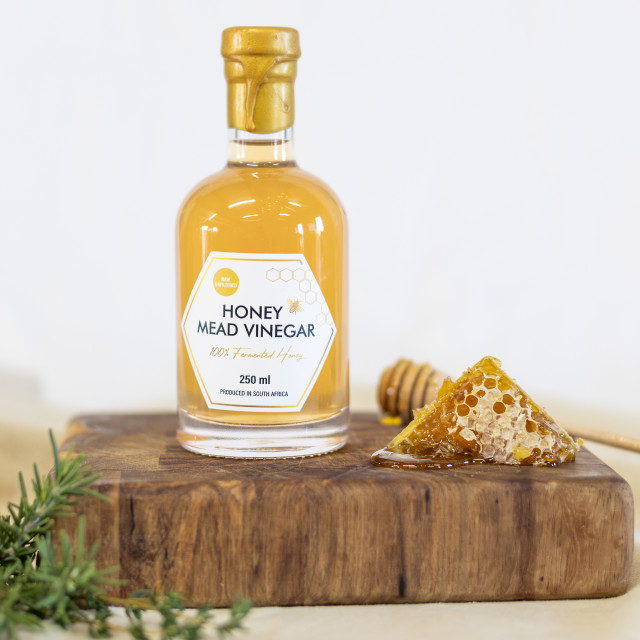 Cape Town Meadery Honey Mead Vinegar, 250ml on a wooden board with honey