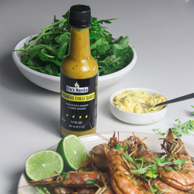 Black Mamba Foods Habanero Chilli Sauce, 180ml with food on the table
