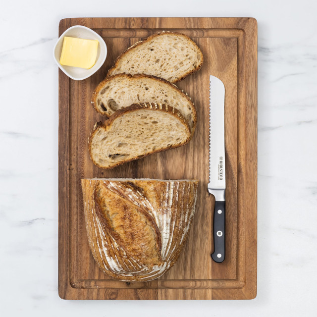 Wolstead Calibre Bread Knife, 20cm on a bread board with bread