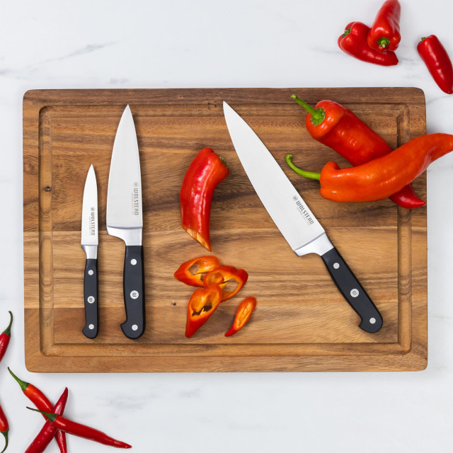 Wolstead Calibre Chef's Knife, 20cm on a cutting board with peppers