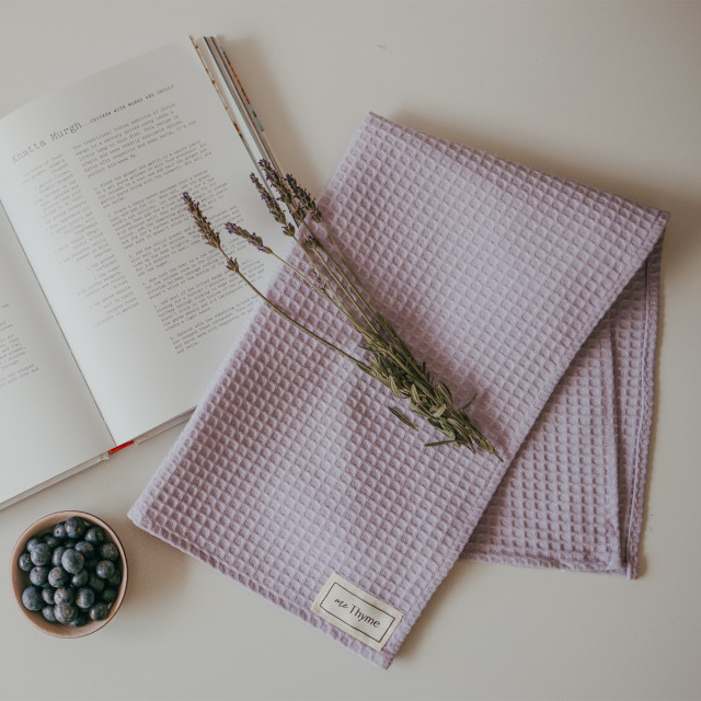Me Thyme Cotton Tea Towel - Pale Purple on the table