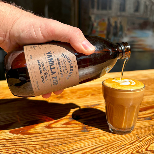 Doubleshot Coffee & Tea Natural Flavour Syrup - Vanilla Pod poured in coffee