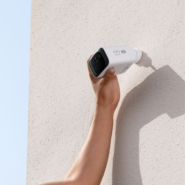 Eufy S220 2K UHD SoloCam Wireless Smart Security Camera Kit being adjusted on the wall