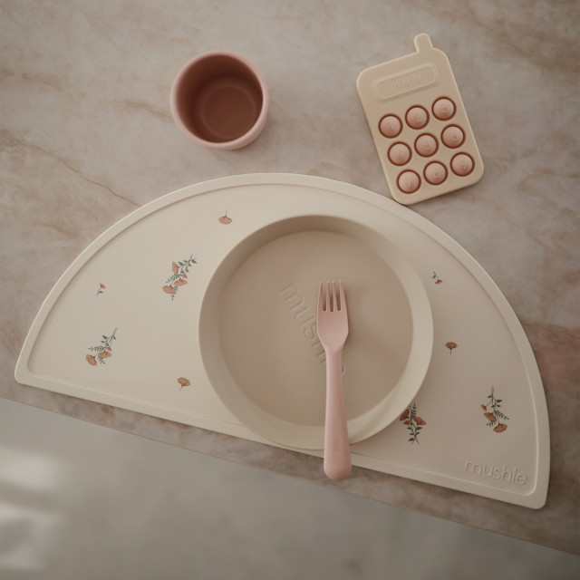 Mushie Silicone Placemat - Pink Flowers on the table