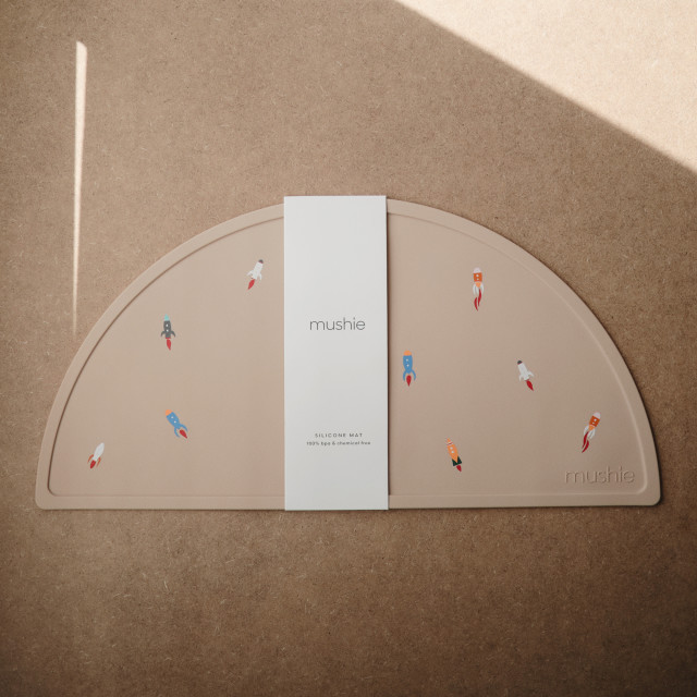 Mushie Silicone Placemat - Rocket packaging on the table