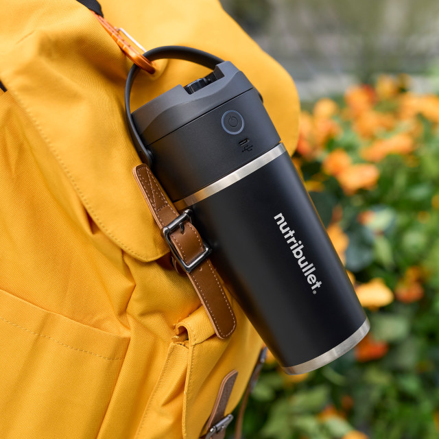 Nutribullet Flip Insulated Portable Blender hung on a backpack
