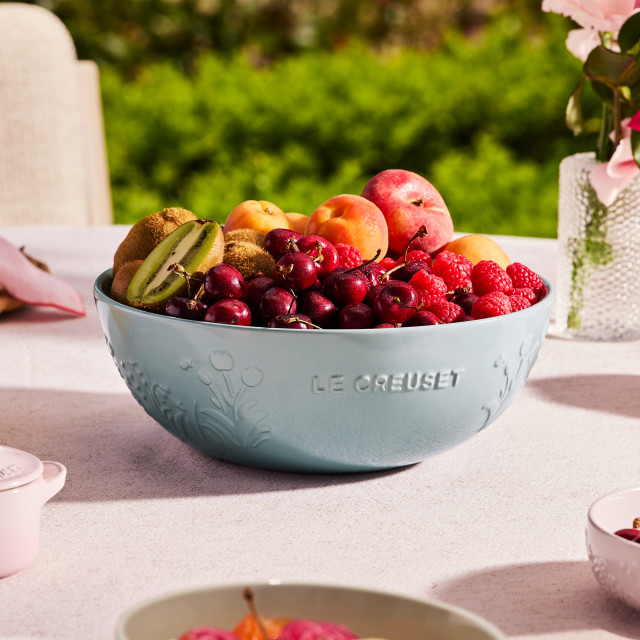 Le Creuset Jardin Relief Stoneware Serving Bowl, 3.6L - Sea Salt with fruits on the table