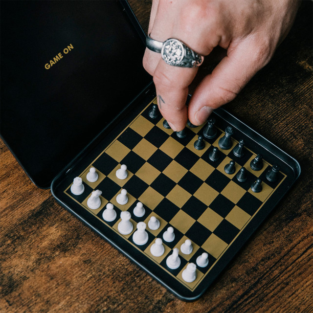 Suck UK Iron & Glory Magnetic Travel Chess Set on the table
