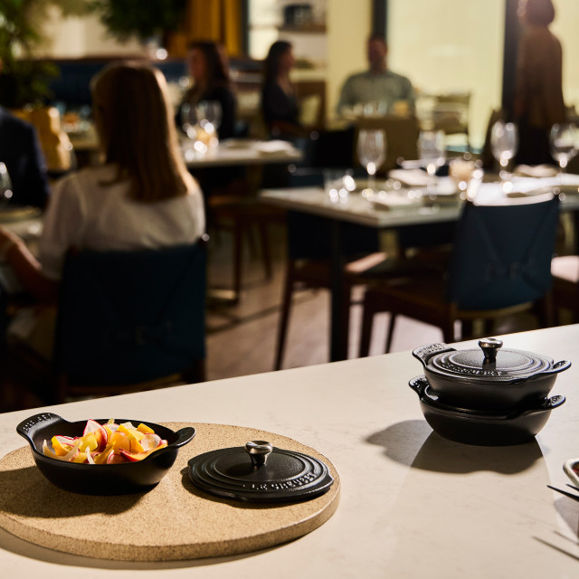 Le Creuset Gourmet Matte Black Collection Cast Iron Mini Braisers with Lids, Set of 4 on the table