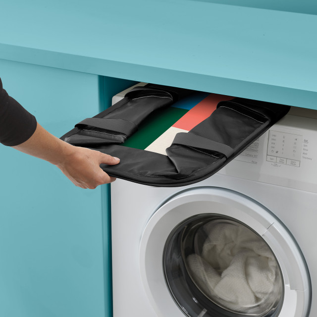 Joseph Joseph Hold-All Jonathan Lawes Collapsible Laundry Basket, 35L stored between the washing machine and shelf