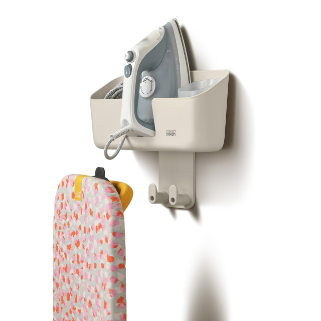 Joseph Joseph IronHub Wall-Mounted Ecru Iron Storage Caddy detail with an iron and ironing board