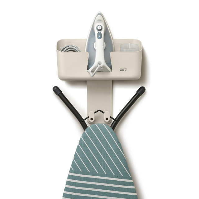 Joseph Joseph IronHub Wall-Mounted Ecru Iron Storage Caddy detail with an iron and ironing board
