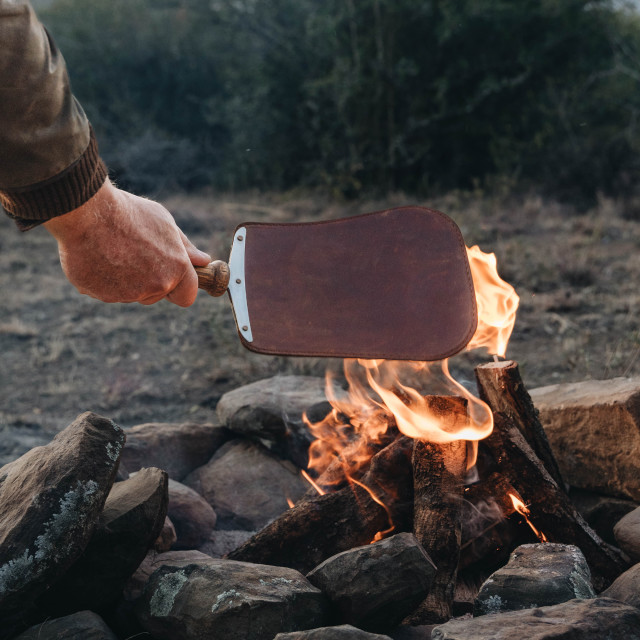 Donkey Long Tong Leather Fire Paddle Fan by the fire