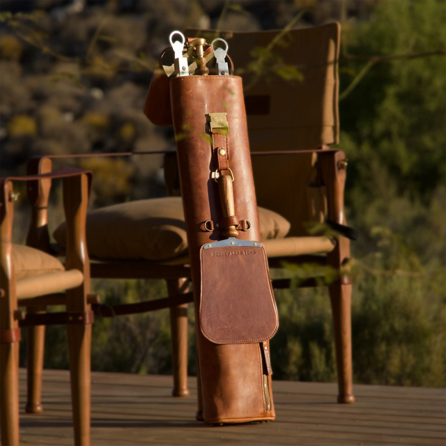 Donkey Long Tong Jack Sack Leather Carry Bag Braai Set next to an outdoor chair